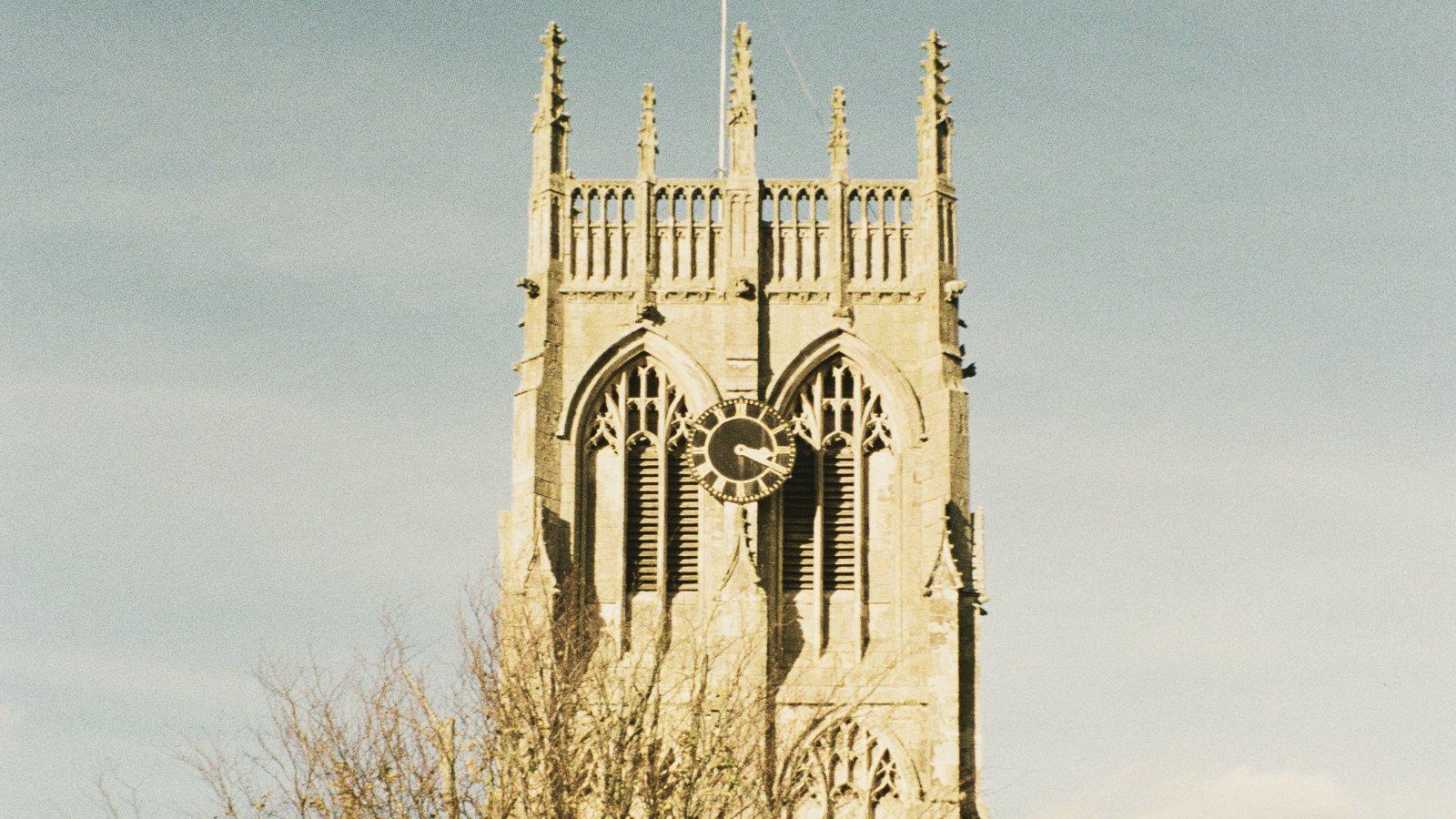 The pinnacled tower of St Augustine's Church in Hedon above autumn trees